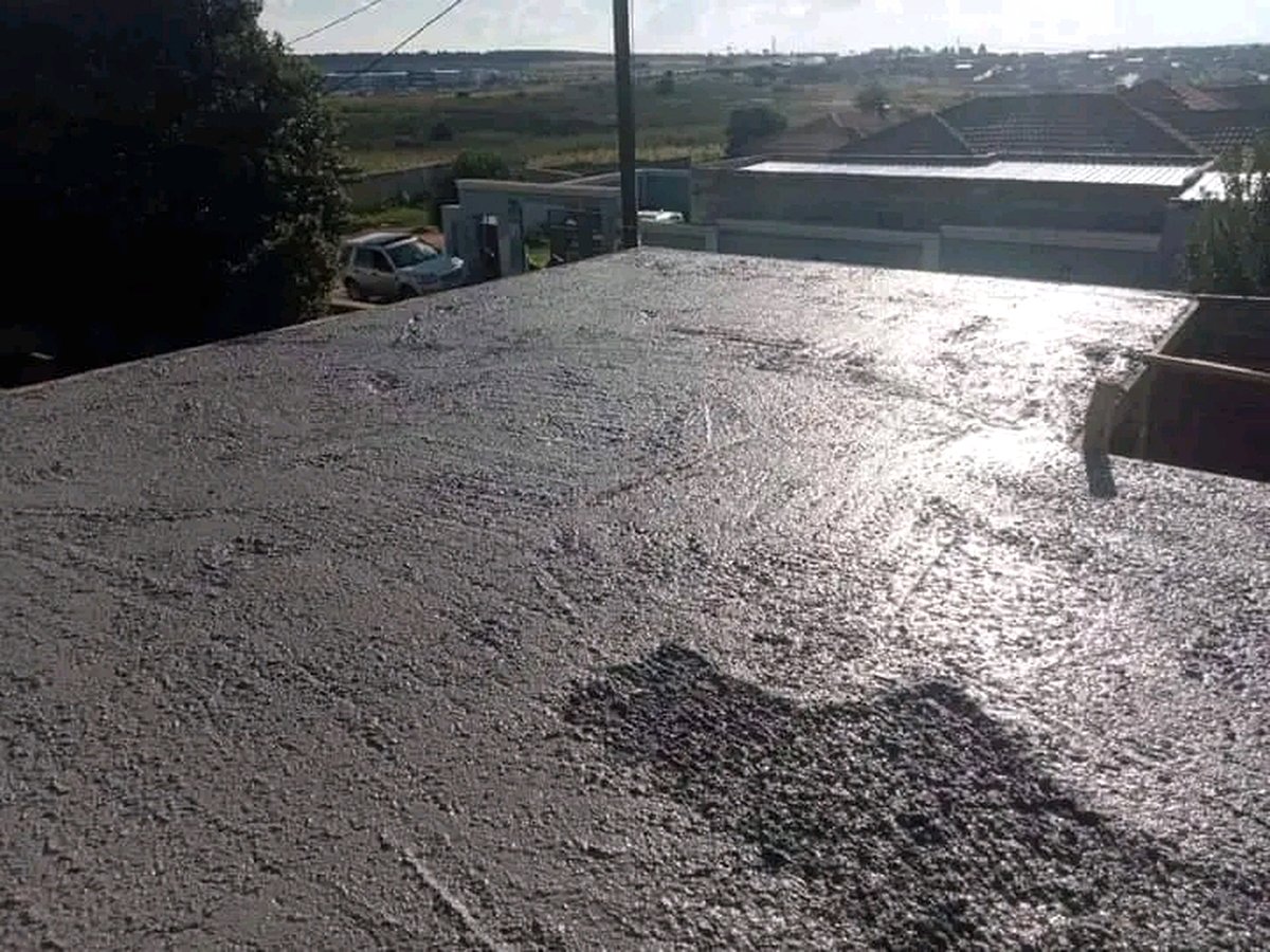 Freshly poured concrete slab surface glistening in sunlight