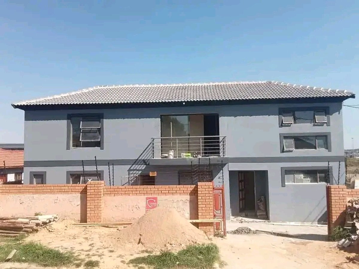 Completed modern gray two-story house with balcony and tiled roof